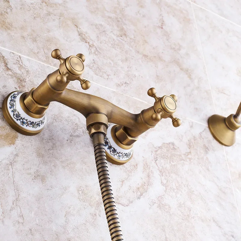 Antique brass twin-handle shower faucet with decorative porcelain escutcheons and flexible hose for wall mount use