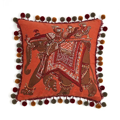 Orangish-red square cushion cover with embroidered elephant and multicolored pom-poms for decorbites american luxe retro decor