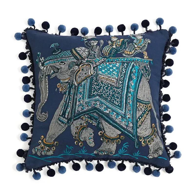 Navy blue velvet cushion cover with embroidered elephant, turquoise gold embellishments, and navy teal pom-poms decorbites american luxe