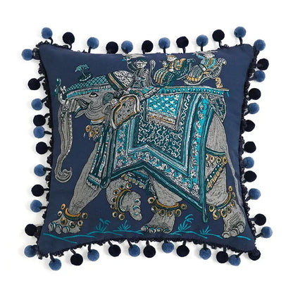 Navy blue velvet cushion cover with embroidered elephant, turquoise gold embellishments, and navy teal pom-poms decorbites american luxe