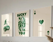 Set of three framed decorbites™ retro wall art posters featuring green playing card and lucky charm designs on cream background