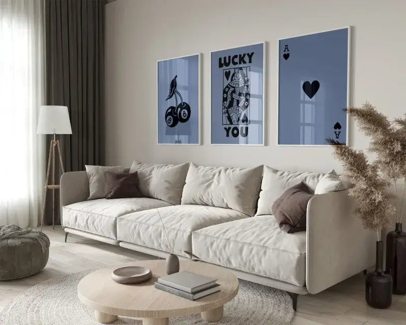 Beige upholstered sectional sofa with soft modern design and dark brown pillows beside retro wall art posters set queen of hearts theme
