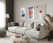 Beige upholstered sectional sofa with dark brown accent pillows in room featuring decorbites wall art posters queen of hearts theme