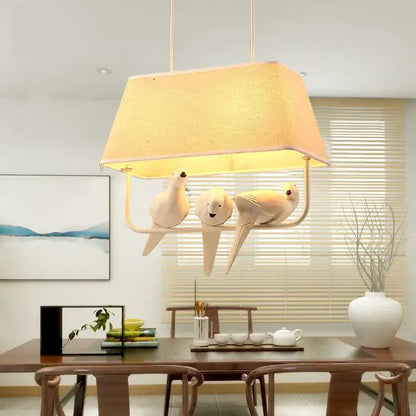 Cream-colored ceramic retro white resin bird cage chandelier with three bird figures under textured warm lampshade