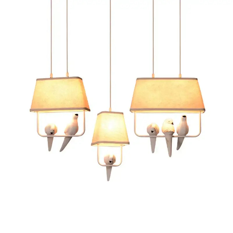 Retro white resin bird cage chandelier with warm fabric shades and white ceramic doves for dining room decorbites bird cage