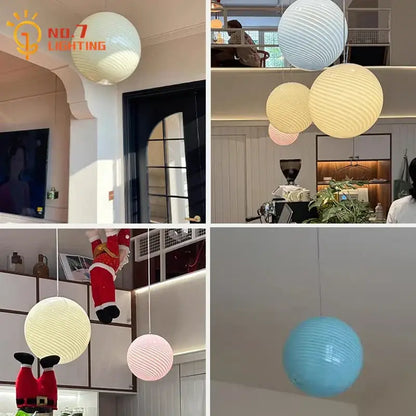Ribbed amber glass pendant lights with spherical shape and warm glow perfect for dining room lighting