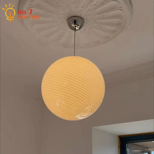 Warm-toned ribbed amber glass pendant light with chrome fixture designed for dining room glass pendant lights