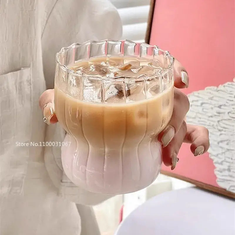 A clear glass coffee cup tumbler with ribbed texture pink gradient base and scalloped rim by Decorbites clear glass