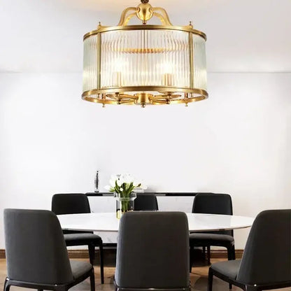 Gold-toned decorbites glass chandelier with vertical ribbed panels and cylindrical frame for living room pendant light