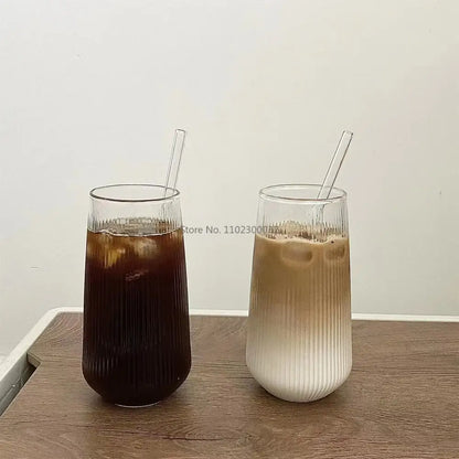 Two tall clear glass cups with vertical ridged texture and matching transparent straws from decorbites clear glass set