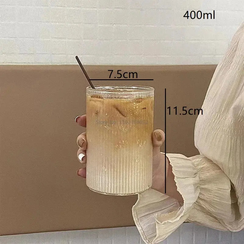 Clear glass coffee tumbler from decorbites set of 6 ribbed glass cups holding iced coffee with dark metal straw