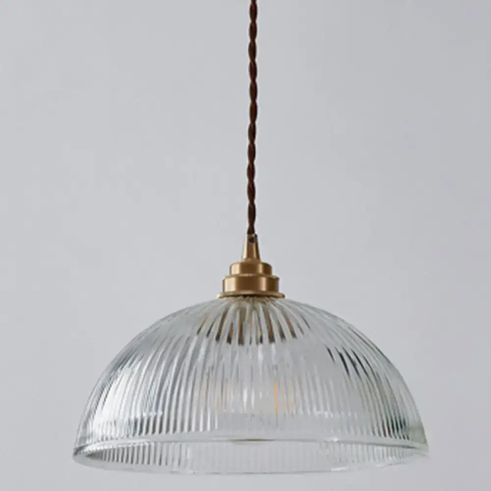 DecorBites™ pendant light with clear ribbed glass and brass fixture hanging by twisted brown cord for dining room use