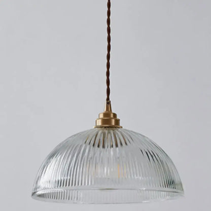 DecorBites™ pendant light with clear ribbed glass and brass fixture hanging by twisted brown cord for dining room use