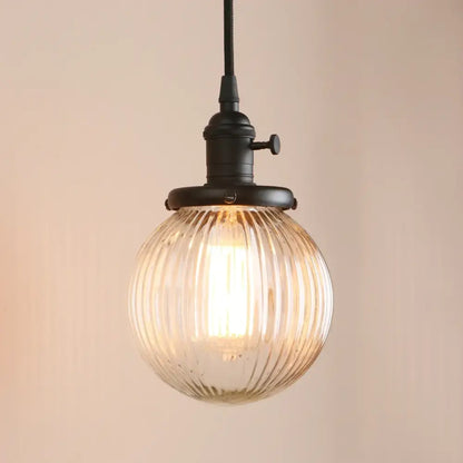 Warm-toned ribbed glass globe pendant light with black metal fixture for living room decorbites clear glass design