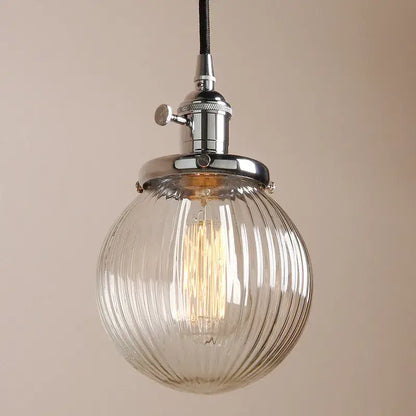 Ribbed glass globe pendant light with clear glass and chrome fixture featuring exposed filament bulb for living room decorbites