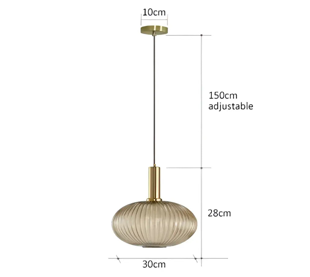 A modern pendant light with a gold-toned metal fixture and oval ribbed glass pendant light shade for dining rooms