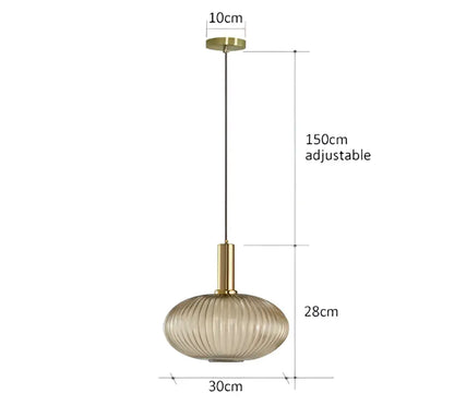 A modern pendant light with a gold-toned metal fixture and oval ribbed glass pendant light shade for dining rooms
