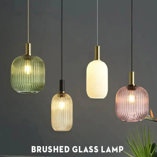Four elegant ribbed glass pendant lights in green cream and pink with brushed gold fixtures for dining rooms