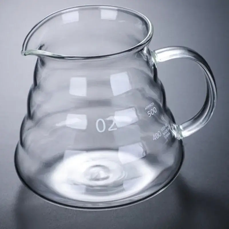 Clear ribbed glass coffee maker pot with curved spout handle and measurement markings for coffee brewing