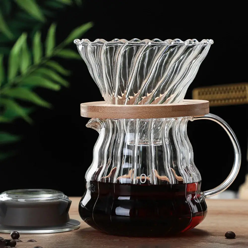 Clear glass ribbed coffee maker pot with fluted design and wooden lid for precise coffee brewing in the kitchen