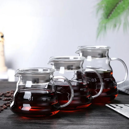 Set of three clear ribbed glass coffee maker pots with numbered markings and stainless steel handles for coffee brewing