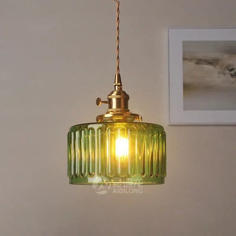 Green ribbed glass pendant light with brass hardware ideal for bedroom use as a stylish glass pendant light