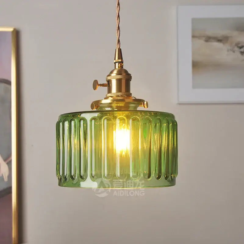 Green ribbed glass pendant light with brass hardware ideal as a stylish glass pendant light for bedroom use