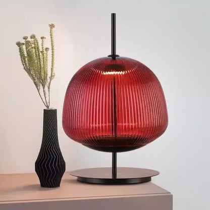 A striking red ribbed glass table lamp with sleek black metal base for decorbites green red bedroom lighting