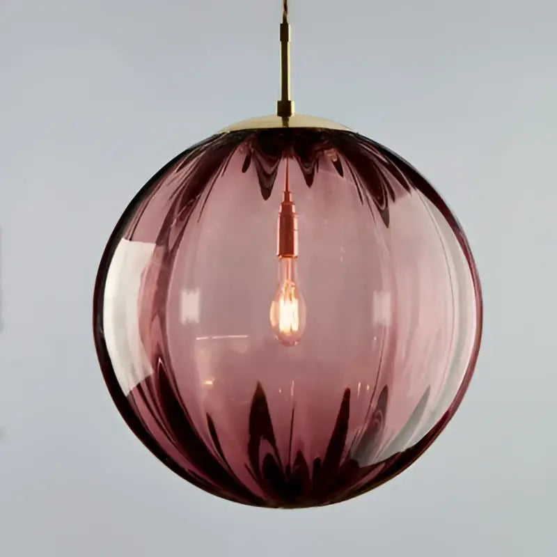 Spherical pendant light with deep purple ribbed glass globe and iron finish, featuring exposed filament bulb for dining room