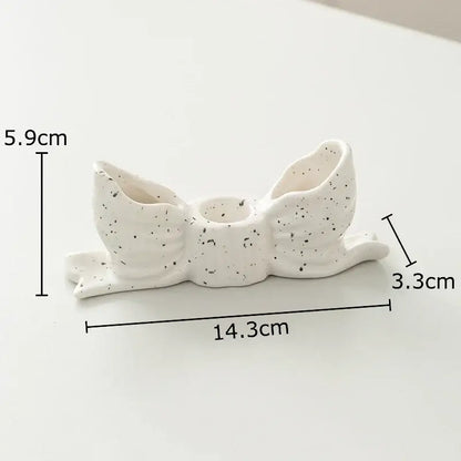 White speckled ceramic bowknot candle holder by decorbites for elegant bedroom desk decor and candle display