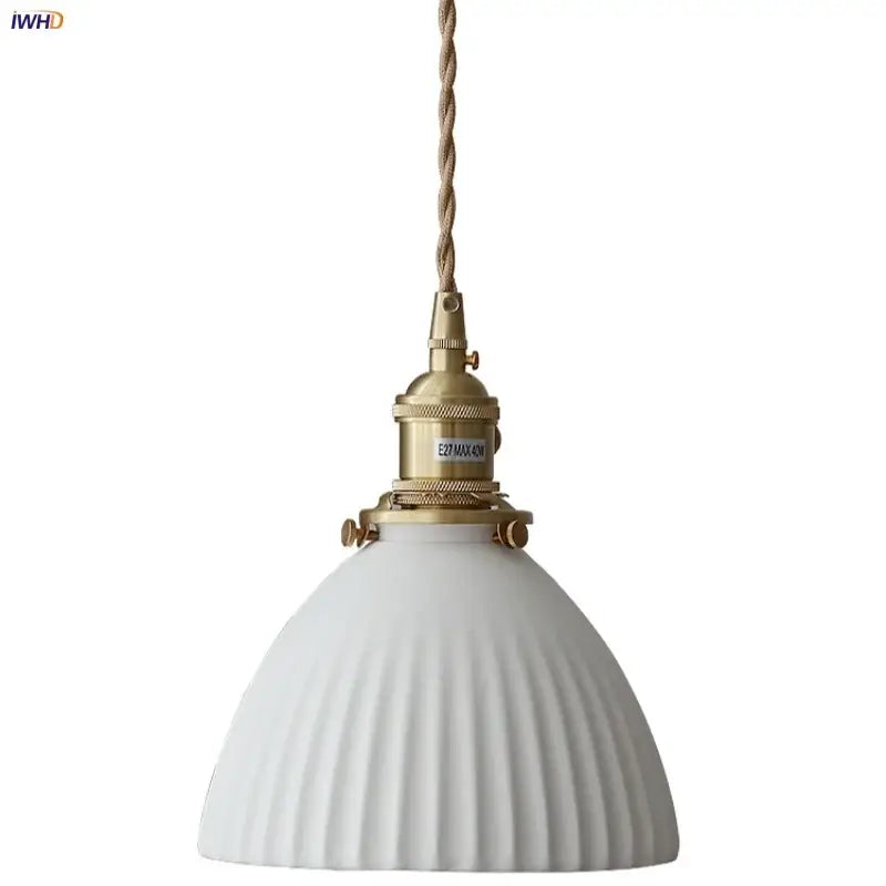 White ribbed ceramic pendant light fixture with brass socket and twisted cord featuring a brass knob switch for kitchen use