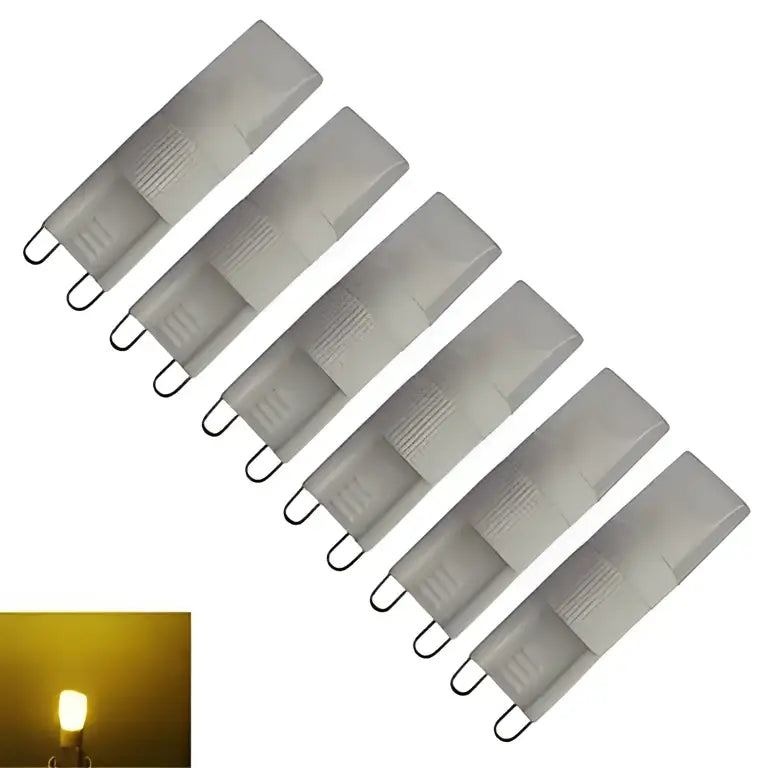 Six translucent gray ribbed decorbites g9 led bulbs with metallic contacts emitting warm yellow glow for living space lighting