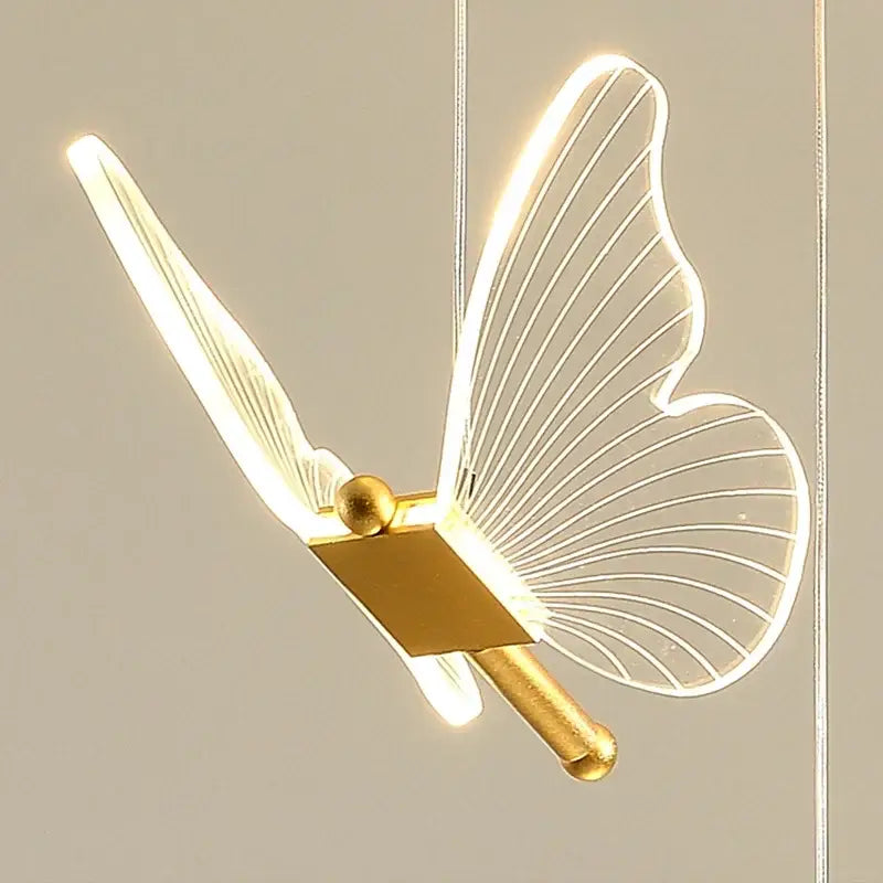 A modern decorbites butterfly led chandelier with translucent wings and gold-toned metallic body for living room decor