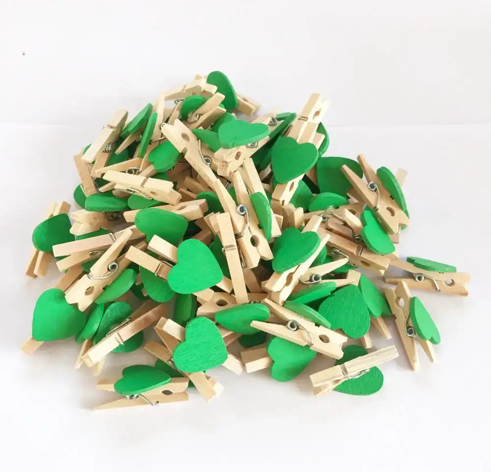 Green heart shape wood clips with natural wood bodies and painted romantic heart shapes for bedroom decor