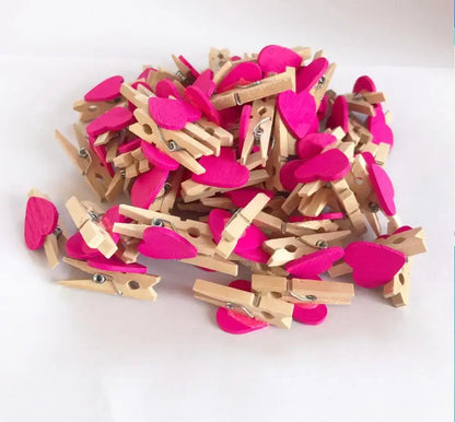 A pile of romantic heart shape wood clips with pink felt accents for multi color bedroom decor