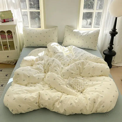 Romantic pink cotton flower print bedding set featuring a cream-colored quilt with delicate gray bows decorbites cotton flower