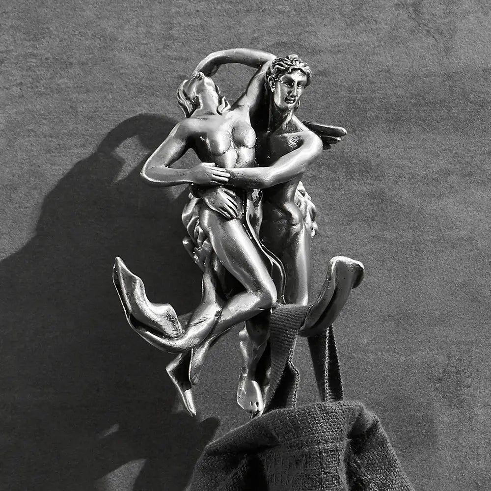 Romantic silver angel bathroom hardware set featuring a silver-toned metal figurine of an embracing male and female figure with a flowing tail