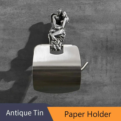 Silver-toned toilet paper holder with ornate romantic couple sculpture, part of romantic silver angel bathroom hardware set