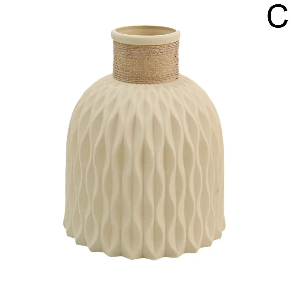 Cream-colored ceramic vase with textured wavy pattern and natural fiber band for living room flower arrangement decor