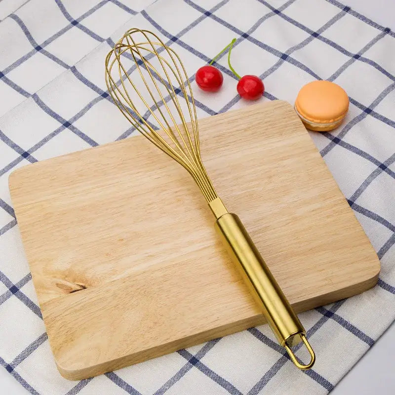 Gold steel egg beater whisk with sleek cylindrical handle and fine wire loops from decorbites gold steel set