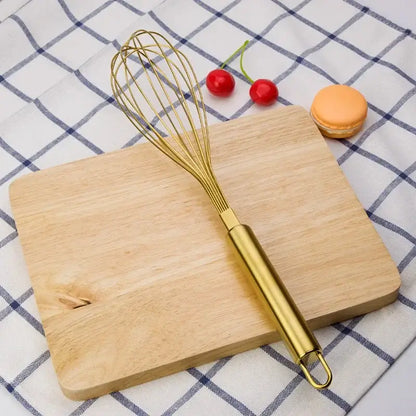 Rose gold and brass steel egg beater whisk with a gold steel egg beater decorbites gold steel handle and fine wire loops