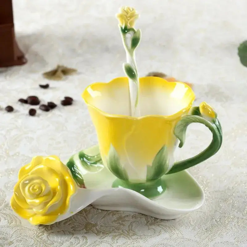 A glossy yellow enamel rose peony ceramic spoon with rose-shaped handle beside a matching peony floral coffee cup set
