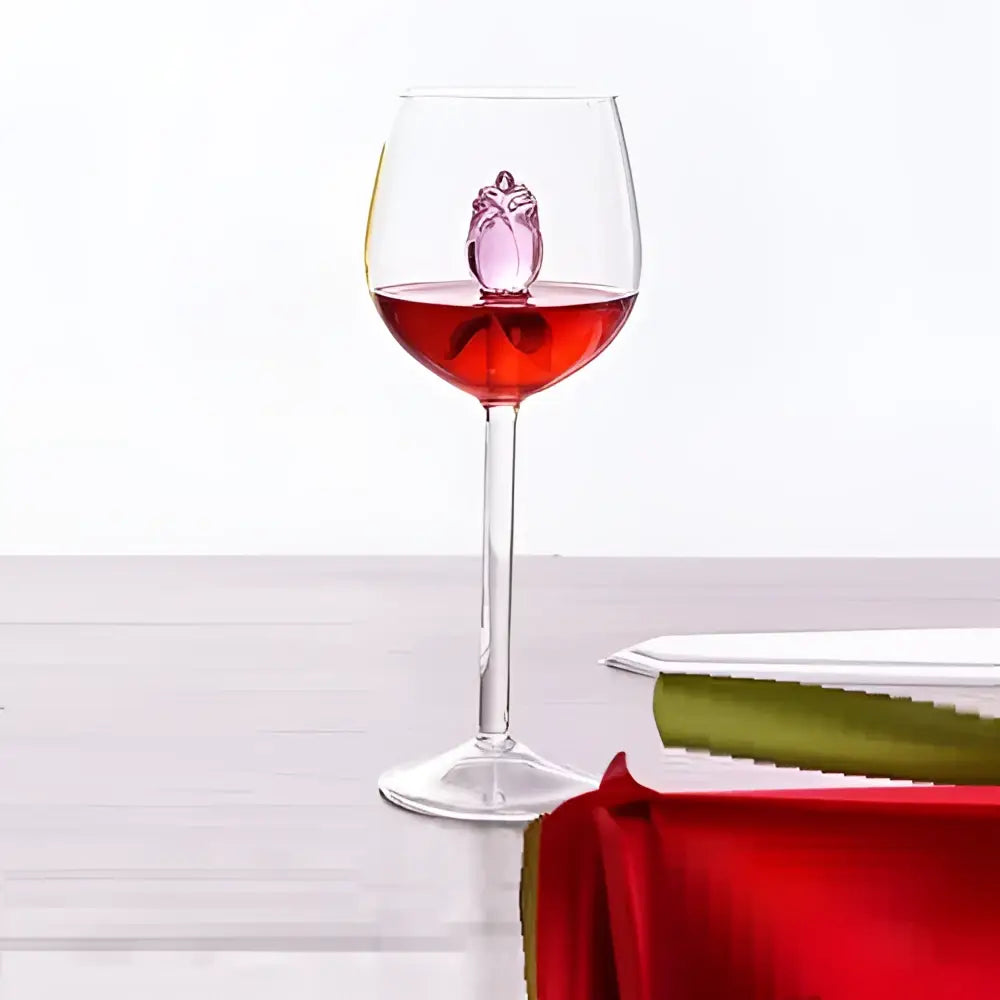 A rose stemware wine glass with pink crystal owl inside filled with red liquid perfect for decorbites 3d rose decor