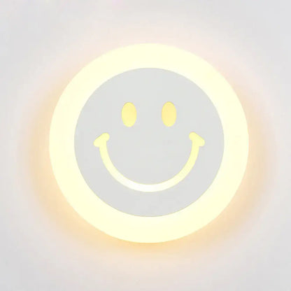 Round led smiley wall sconce with warm white light and soft yellow glow featuring a minimalist gray center design