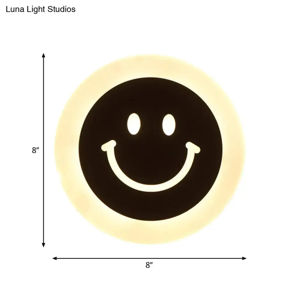 Round led smiley wall sconce with circular black face and warm white light cream halo for bedroom decor