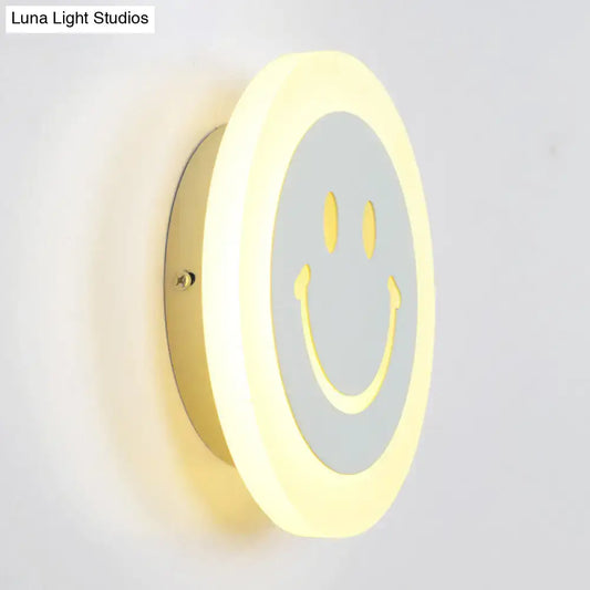 Round led smiley wall sconce with warm white light featuring a gray center and yellow eyes for bedroom decor