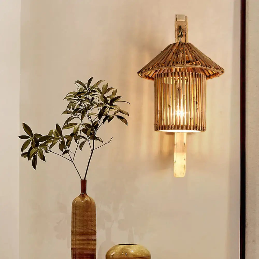Rustic warm-toned bamboo cylinder house sconce light fixture with tiered woven design and vertical slats for bedroom wall