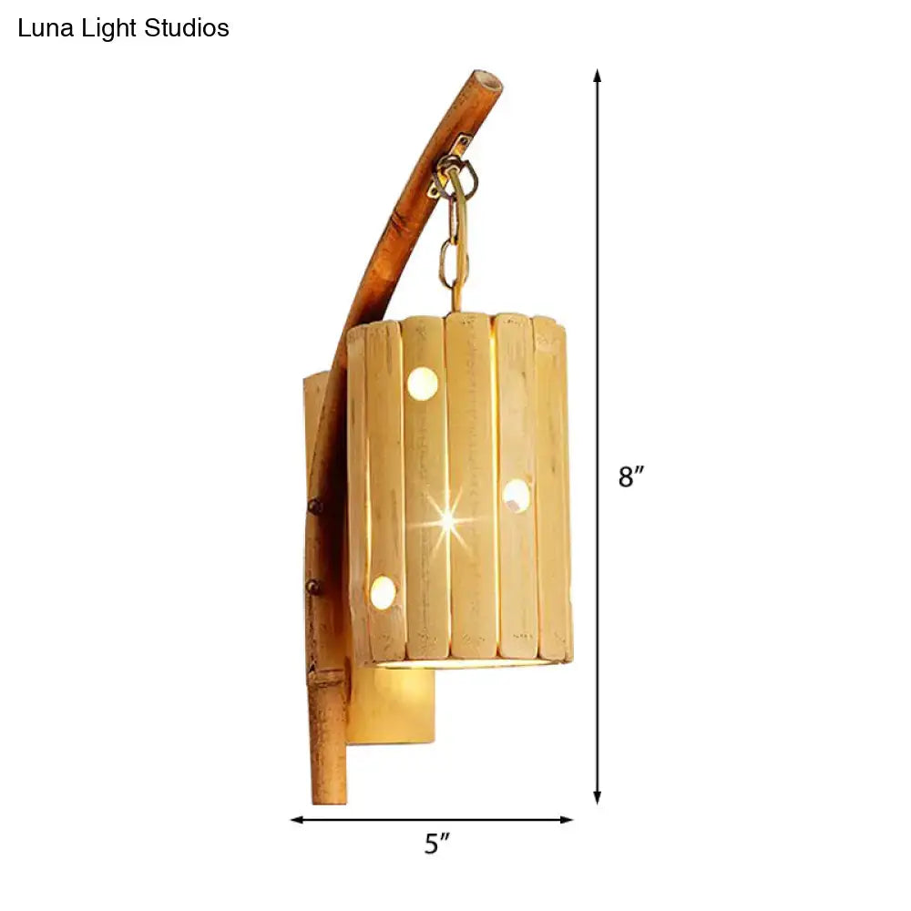 Rustic bamboo cylinder house sconce light fixture with curved wooden arm and vertical slats for bedroom wall lamp
