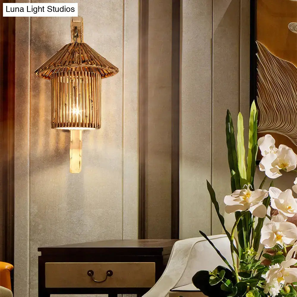 Rustic warm-toned bamboo wood cylinder house sconce light fixture with woven pagoda top and vertical slats for bedroom