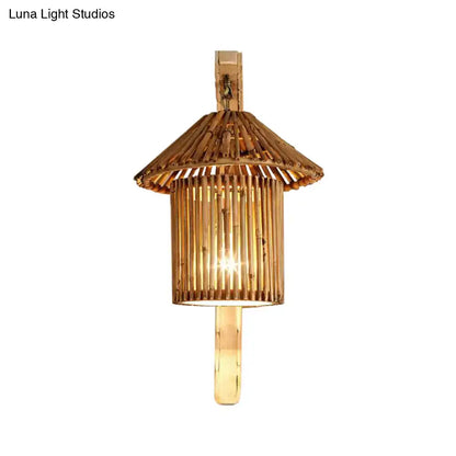 Handcrafted rustic bamboo cylinder house sconce light fixture with warm golden glow and pagoda-inspired design
